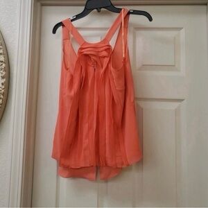 BCBGMaxAzria fishtail Sleeveless Chiffon Top is a size Small.